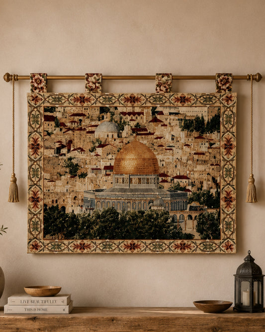 Large Al Aqsa Mosque decorative tapestry featuring the golden Dome of the Rock, elegantly displayed above a rustic wooden console table with books, lantern decor, and natural accents in a cozy Mediterranean-inspired interior.