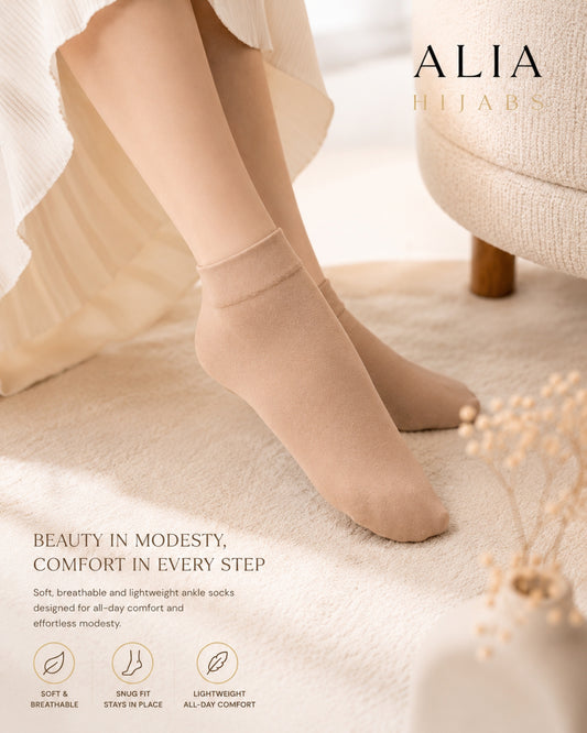 Beige ankle socks worn by a person, with 'Alia' branding and product features listed.