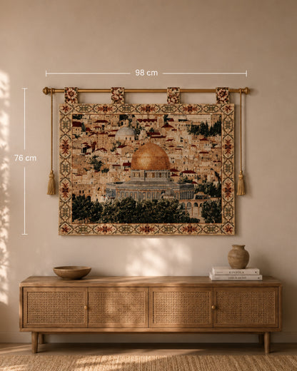 Al Aqsa Mosque woven wall tapestry displayed above a natural wood console table in a warm, neutral-toned living room. The tapestry features the golden Dome of the Rock and intricate floral borders, with size dimensions shown as 98 cm x 76 cm for scale reference.