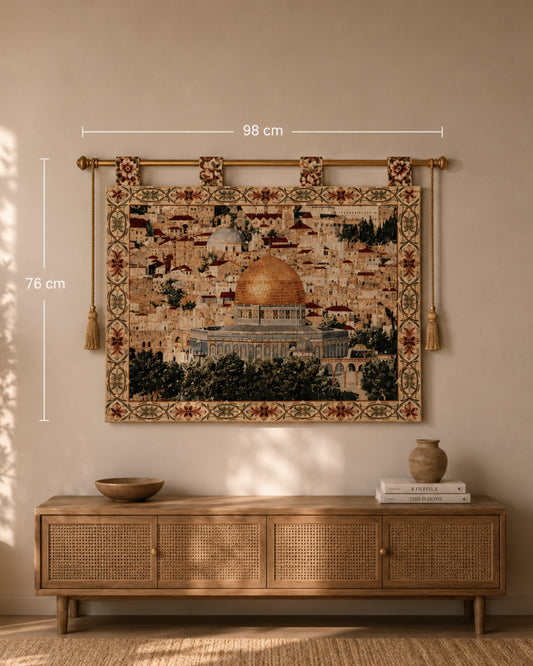 Al Aqsa Mosque woven wall tapestry displayed above a natural wood console table in a warm, neutral-toned living room. The tapestry features the golden Dome of the Rock and intricate floral borders, with size dimensions shown as 98 cm x 76 cm for scale reference.