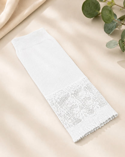 White Lycra arm sleeve featuring delicate lace trim, displayed flat on a neutral fabric background with botanical accents, designed for modest coverage and comfort.