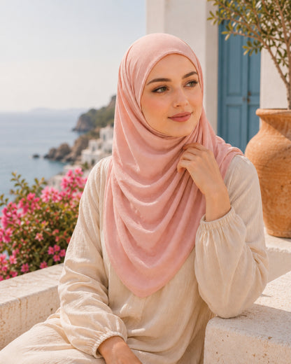 DAMAS Blush Peach two-piece lightweight cotton hijab worn by a model on a Mediterranean terrace, featuring breathable fabric, full coverage, and comfortable everyday styling.