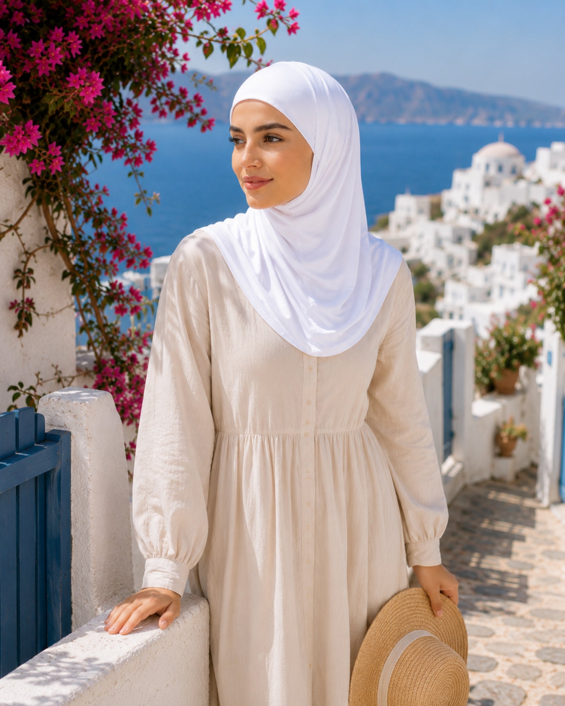 Layal White two-piece Lycra hijab with lightweight stretch fabric and full coverage, styled in a Mediterranean summer setting for comfortable modest fashion.