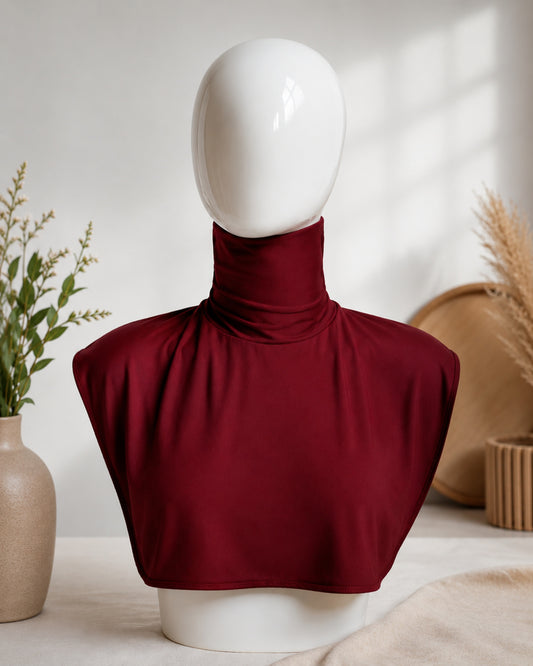 Maroon top on a mannequin bust with a neutral background

