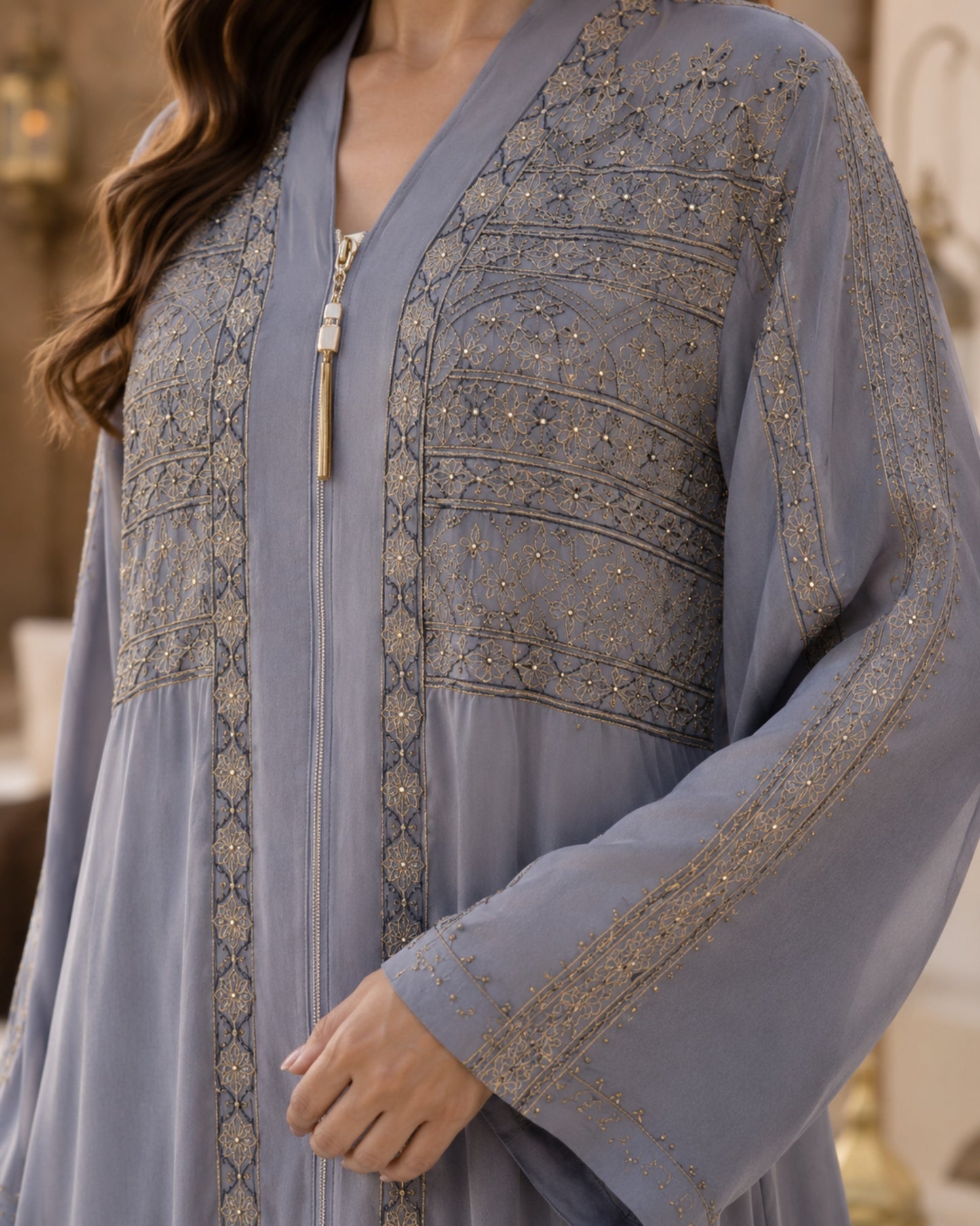 Light blue embroidered dress with intricate patterns on a blurred background

