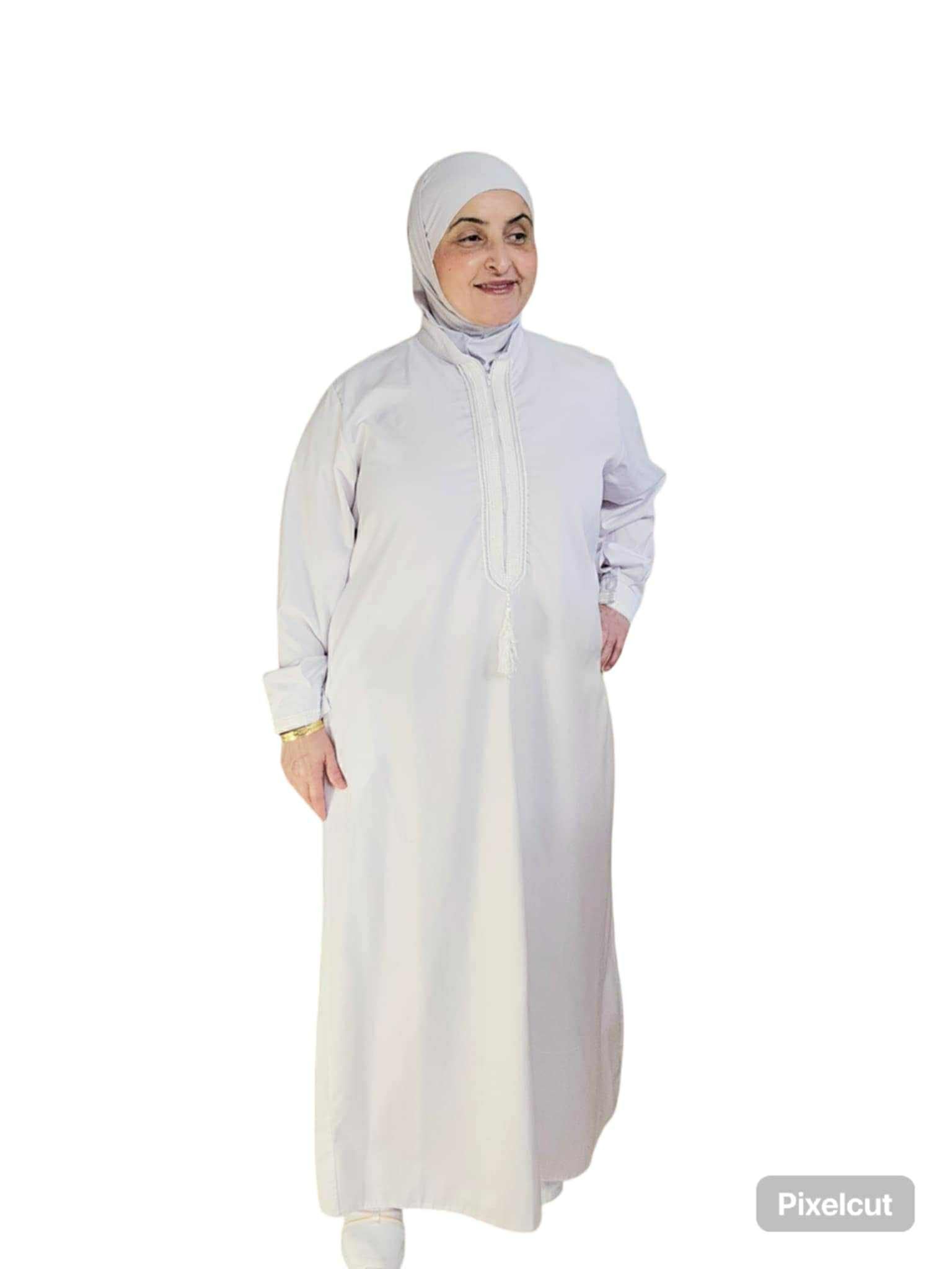 Woman wearing a white abaya and headscarf on a white background